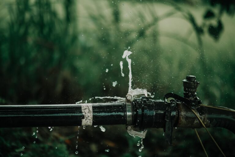 Water spraying from a split pipe joint after a burst pipe in a home