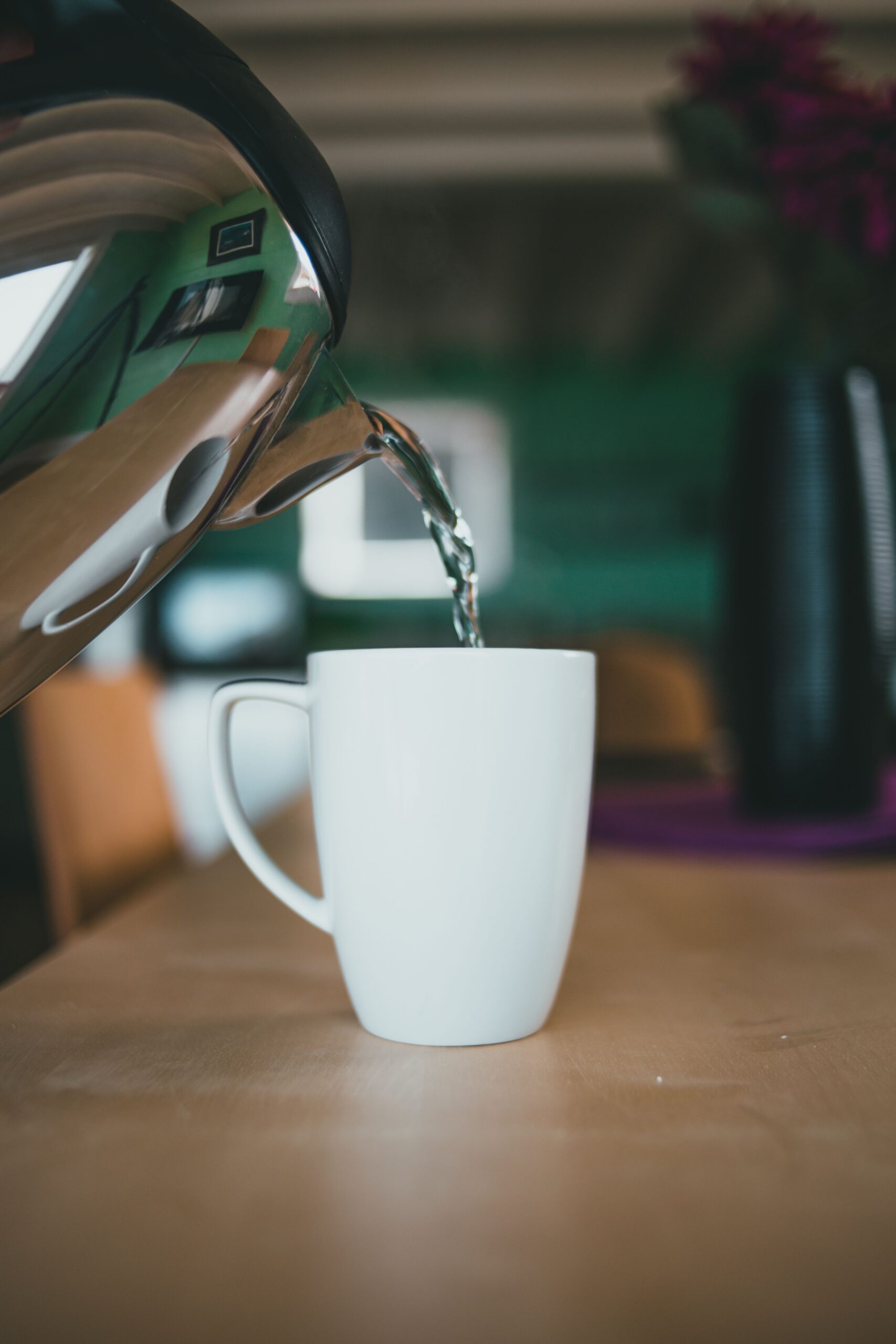 Kettle pouring hot water — warm (not boiling) water is used to thaw a frozen condensate pipe