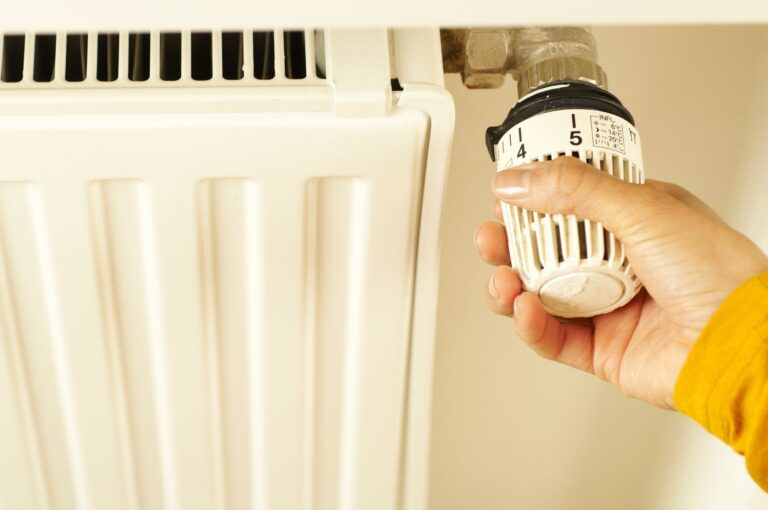 Hand turning a thermostatic radiator valve up, one of the first checks when the heating does not come on