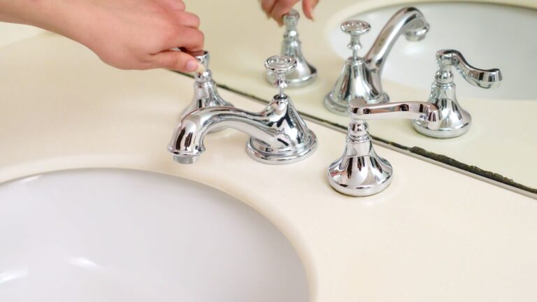 Hand turning a chrome bathroom tap, one of the everyday plumbing jobs covered in this guide to plumber costs in Bradford