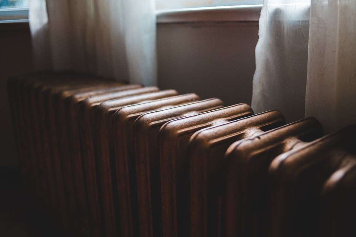 Older cast-iron radiator under a window in a Bradford home